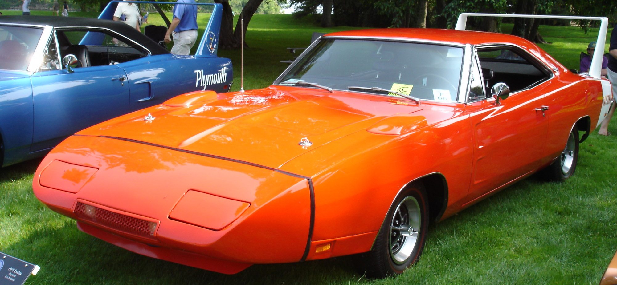 An orange Dodge Daytona next to a Plymouth Superbird